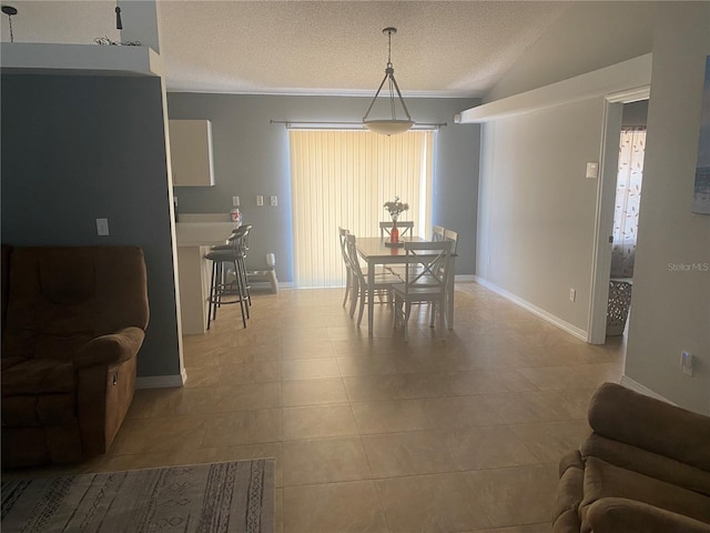 1602 Taylor Lake Cir, Largo, FL 33778 - dining room with a textured ceiling, plenty of natural light, tile patterned floors, vaulted ceiling, and crown molding