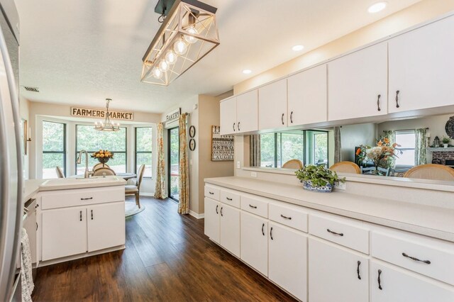 8549 Pinafore Dr, New Port Richey, FL 34653 - kitchen featuring a chandelier, dark wood-style flooring, healthy amount of natural light, light countertops, and recessed lighting