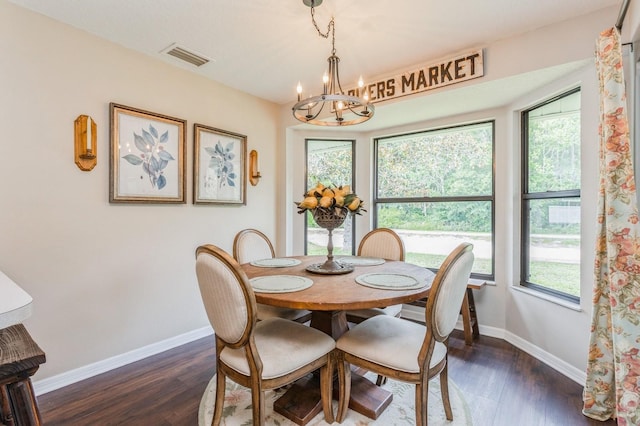 8549 Pinafore Dr, New Port Richey, FL 34653 - dining space with a chandelier, baseboards, dark wood-style flooring, and healthy amount of natural light