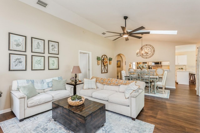 8549 Pinafore Dr, New Port Richey, FL 34653 - living room with dark wood-style flooring, arched walkways, a ceiling fan, a chandelier, and baseboards