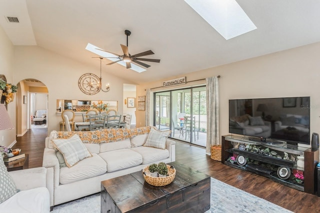 8549 Pinafore Dr, New Port Richey, FL 34653 - living room featuring a skylight, lofted ceiling, arched walkways, a chandelier, and wood finished floors