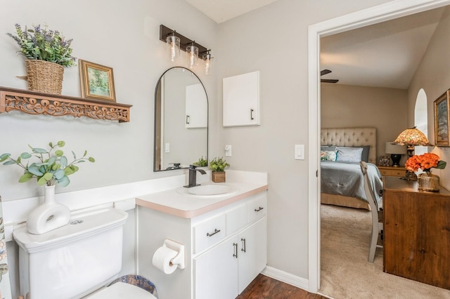 8549 Pinafore Dr, New Port Richey, FL 34653 - ensuite bathroom with vanity, toilet, wood finished floors, and baseboards