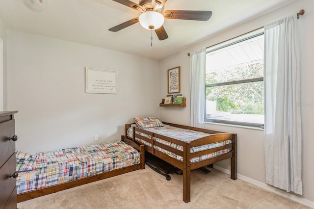 8549 Pinafore Dr, New Port Richey, FL 34653 - bedroom featuring light colored carpet, baseboards, and ceiling fan