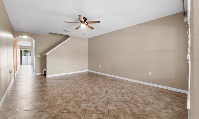 9752 Trumpet Vine Loop, Trinity, FL 34655 - tiled empty room with a ceiling fan, arched walkways, and baseboards