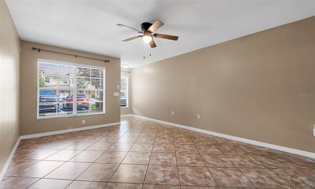 9752 Trumpet Vine Loop, Trinity, FL 34655 - tiled spare room featuring a ceiling fan, baseboards, and a textured ceiling