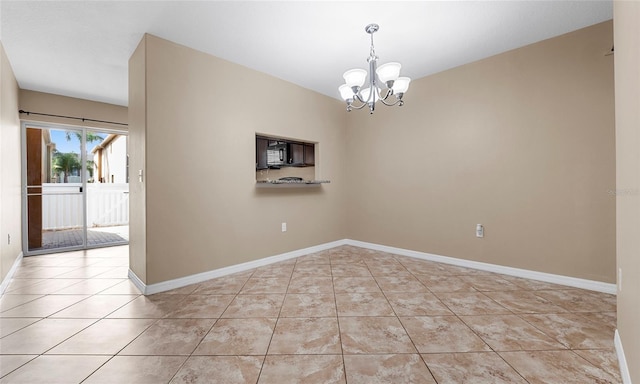 9752 Trumpet Vine Loop, Trinity, FL 34655 - unfurnished room with a chandelier, light tile patterned flooring, and baseboards