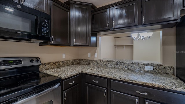 9752 Trumpet Vine Loop, Trinity, FL 34655 - kitchen with stainless steel electric range, black microwave, light stone countertops, and a chandelier