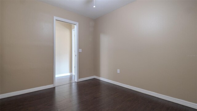 9752 Trumpet Vine Loop, Trinity, FL 34655 - unfurnished room with dark wood finished floors and baseboards
