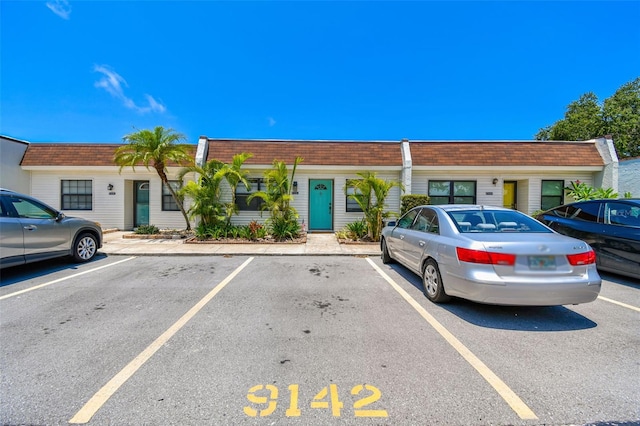 9142 Oakwood Ln, Seminole, FL 33776 - view of property with uncovered parking and mansard roof