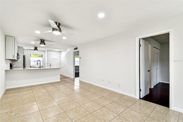 9142 Oakwood Ln, Seminole, FL 33776 - unfurnished living room featuring recessed lighting, ceiling fan, light tile patterned floors, baseboards, and a sink