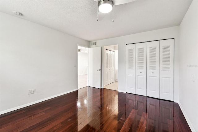 9142 Oakwood Ln, Seminole, FL 33776 - unfurnished bedroom with hardwood / wood-style floors, baseboards, two closets, and a ceiling fan