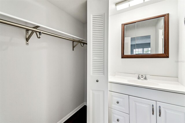 9142 Oakwood Ln, Seminole, FL 33776 - bathroom featuring vanity, baseboards, and a closet