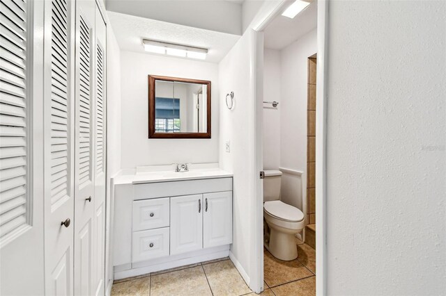 9142 Oakwood Ln, Seminole, FL 33776 - full bathroom with a closet, vanity, tile patterned flooring, and toilet