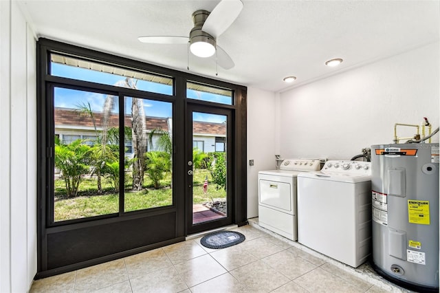 9142 Oakwood Ln, Seminole, FL 33776 - laundry area with electric water heater, washing machine and clothes dryer, ceiling fan, and light tile patterned flooring
