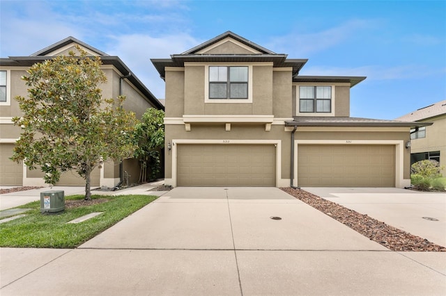 5153 Bay Isle Cir, Clearwater, FL 33760 - view of front of property with concrete driveway, stucco siding, and a garage