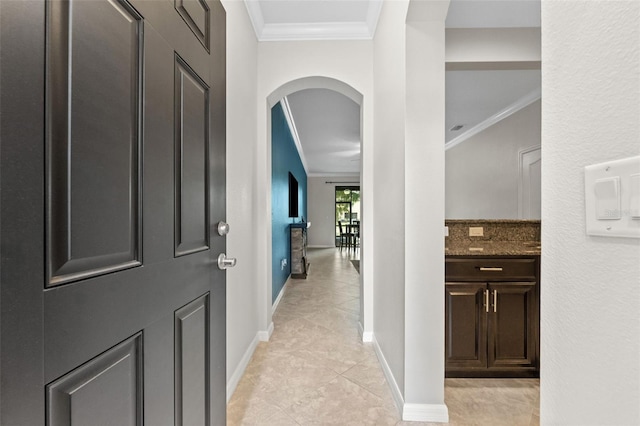 5153 Bay Isle Cir, Clearwater, FL 33760 - corridor featuring arched walkways, ornamental molding, light tile patterned floors, and baseboards