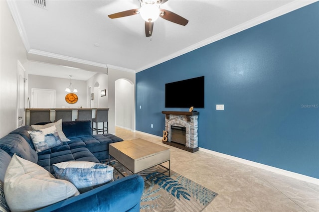 5153 Bay Isle Cir, Clearwater, FL 33760 - living area with arched walkways, crown molding, a ceiling fan, and baseboards