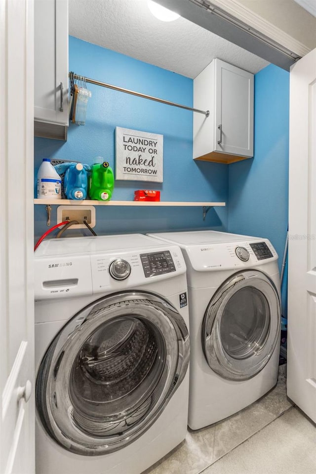5153 Bay Isle Cir, Clearwater, FL 33760 - laundry area with cabinet space, washing machine and dryer, and tile patterned flooring