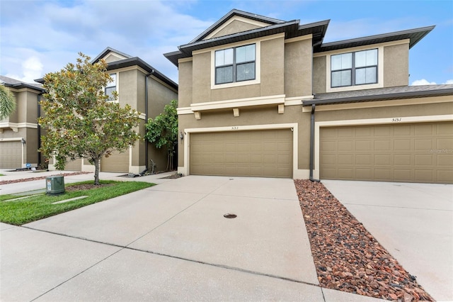 5153 Bay Isle Cir, Clearwater, FL 33760 - multi unit property with stucco siding, driveway, and a garage