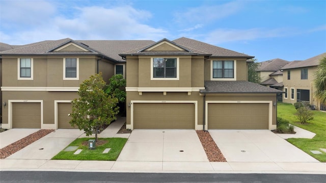 5153 Bay Isle Cir, Clearwater, FL 33760 - multi unit property with stucco siding, an attached garage, and driveway