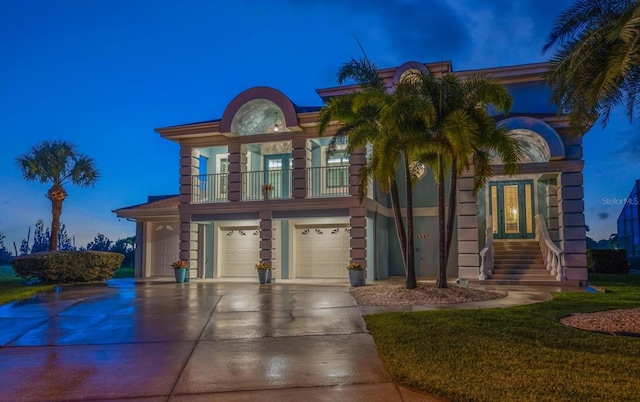3397 Bluefish Dr, Hernando Beach, FL 34607 - view of front of home featuring a balcony, a garage, driveway, french doors, and a front yard