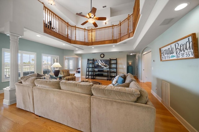 3397 Bluefish Dr, Hernando Beach, FL 34607 - living area with ceiling fan, light wood-type flooring, decorative columns, arched walkways, and a high ceiling