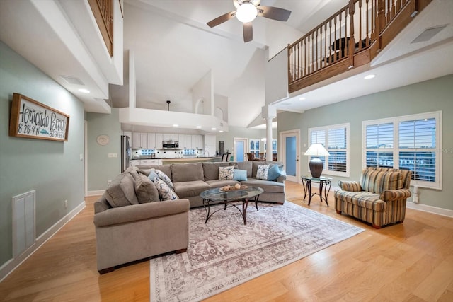 3397 Bluefish Dr, Hernando Beach, FL 34607 - living room featuring light wood-type flooring, ceiling fan, and a high ceiling