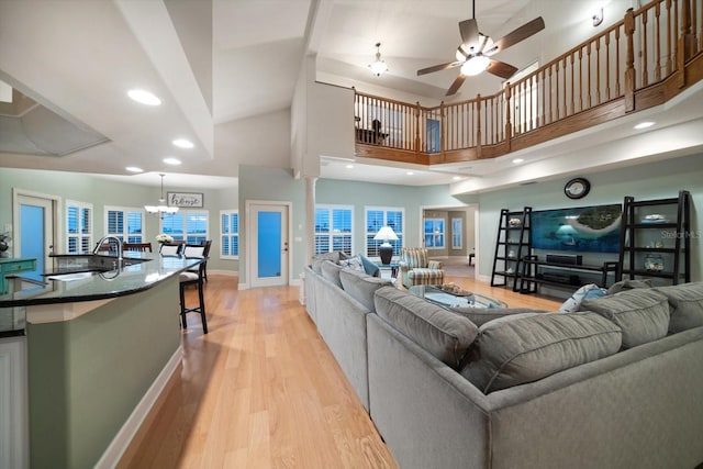 3397 Bluefish Dr, Hernando Beach, FL 34607 - living room with light wood finished floors, ceiling fan, a high ceiling, and recessed lighting