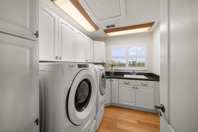 3397 Bluefish Dr, Hernando Beach, FL 34607 - washroom featuring cabinet space, washer and dryer, and light wood finished floors