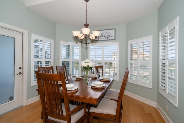 3397 Bluefish Dr, Hernando Beach, FL 34607 - dining room featuring a chandelier, light wood-type flooring, and healthy amount of natural light