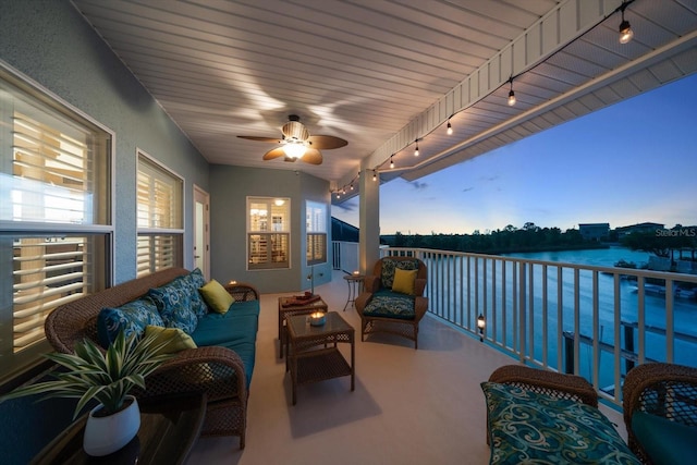 3397 Bluefish Dr, Hernando Beach, FL 34607 - balcony at dusk with a water view, a ceiling fan, and an outdoor living space