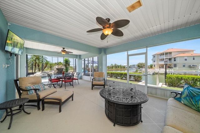 3397 Bluefish Dr, Hernando Beach, FL 34607 - sunroom / solarium featuring ceiling fan, a water view, and an outdoor hangout area