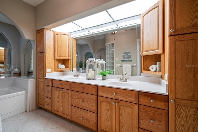 3397 Bluefish Dr, Hernando Beach, FL 34607 - full bathroom featuring double vanity, tile patterned floors, and a tub to relax in
