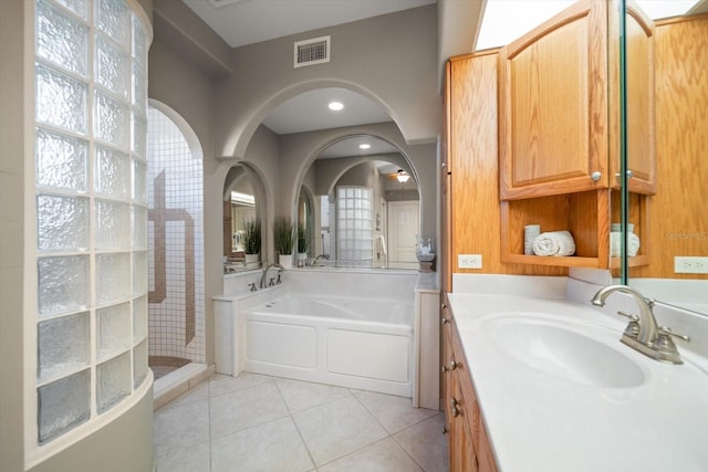 3397 Bluefish Dr, Hernando Beach, FL 34607 - full bathroom with vanity, a garden tub, tile patterned floors, and tiled shower