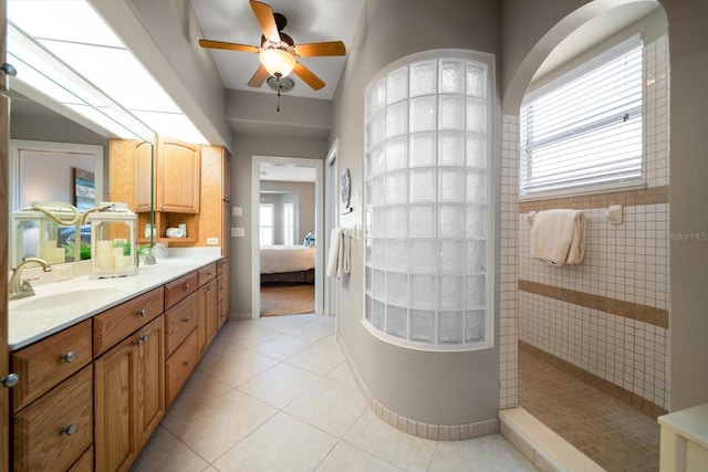 3397 Bluefish Dr, Hernando Beach, FL 34607 - bathroom with ensuite bathroom, a ceiling fan, walk in shower, double vanity, and tile patterned floors