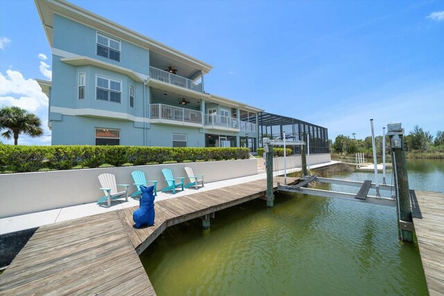 3397 Bluefish Dr, Hernando Beach, FL 34607 - dock with boat lift, a water view, and a balcony