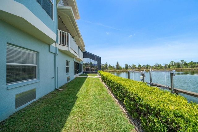 3397 Bluefish Dr, Hernando Beach, FL 34607 - view of green lawn with boat lift, a water view, and a dock