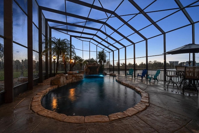 3397 Bluefish Dr, Hernando Beach, FL 34607 - pool at dusk featuring a patio, an outdoor pool, and glass enclosure