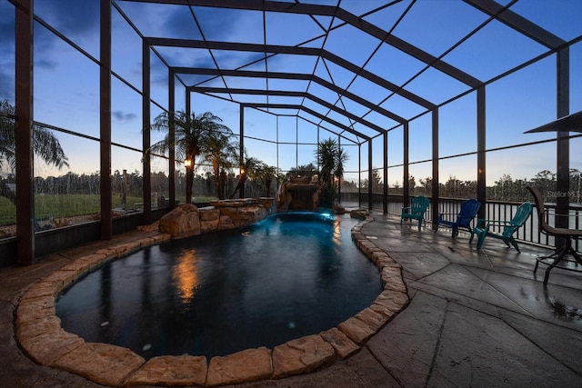 3397 Bluefish Dr, Hernando Beach, FL 34607 - pool at dusk with a patio area, an outdoor pool, and glass enclosure