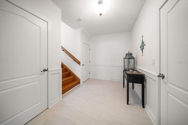 3397 Bluefish Dr, Hernando Beach, FL 34607 - hallway featuring a textured ceiling and stairway
