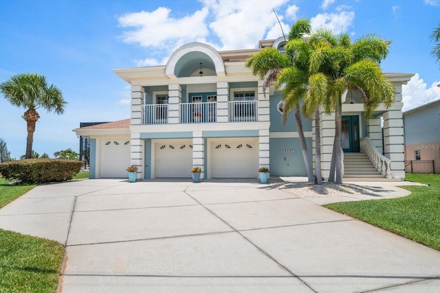3397 Bluefish Dr, Hernando Beach, FL 34607 - view of front facade with driveway, a garage, a balcony, and stucco siding