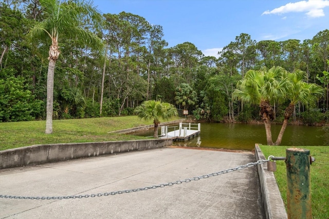3397 Bluefish Dr, Hernando Beach, FL 34607 - dock with a boat ramp, a yard, and a water view