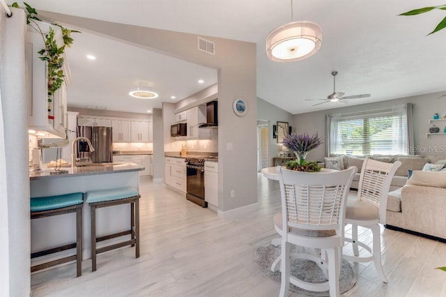 64 Alberta Ave, Ponce Inlet, FL 32127 - dining area with a ceiling fan, light wood-style floors, vaulted ceiling, and recessed lighting