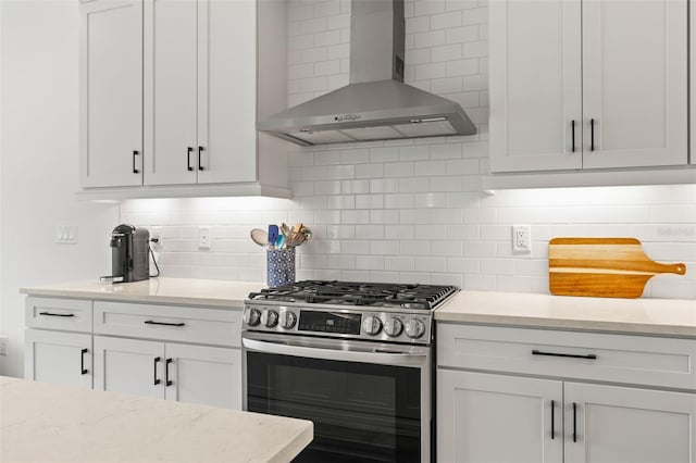 3541 Great Banyan Way, Wesley Chapel, FL 33543 - kitchen featuring gas range, wall chimney exhaust hood, backsplash, white cabinets, and light stone countertops