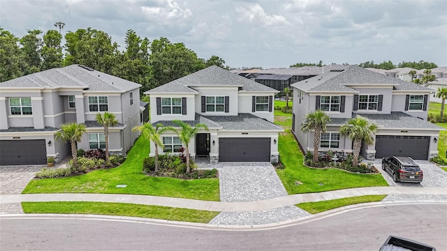 3541 Great Banyan Way, Wesley Chapel, FL 33543 - view of front of house featuring stucco siding, a residential view, decorative driveway, and a front yard