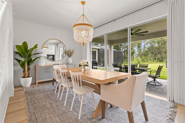 3541 Great Banyan Way, Wesley Chapel, FL 33543 - dining space featuring wood finished floors, a chandelier, and a ceiling fan