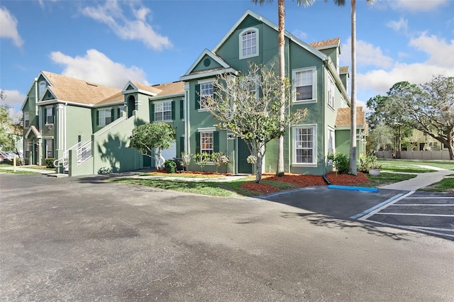 10412 White Lake Ct, Tampa, FL 33626 - view of property featuring stucco siding and uncovered parking