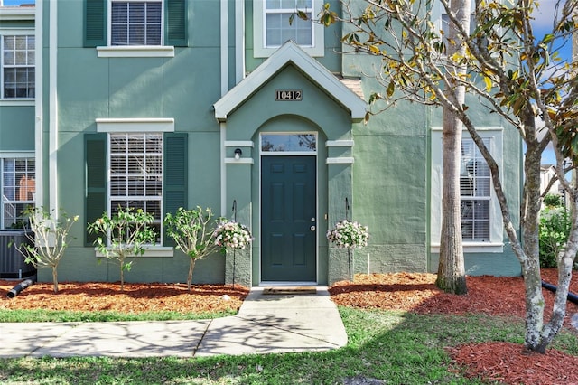 10412 White Lake Ct, Tampa, FL 33626 - view of exterior entry with central air condition unit and stucco siding