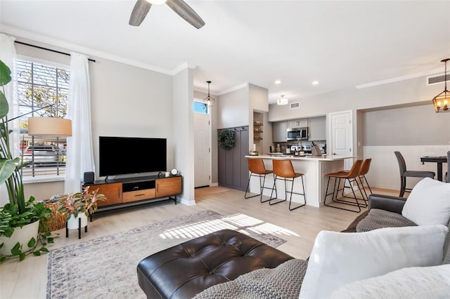 10412 White Lake Ct, Tampa, FL 33626 - living room featuring crown molding, light wood finished floors, a ceiling fan, baseboards, and recessed lighting