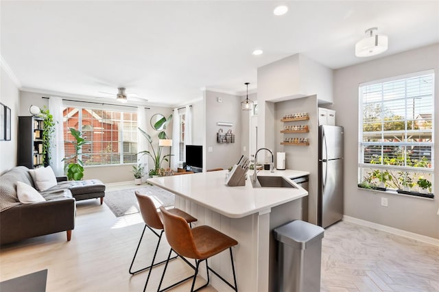 10412 White Lake Ct, Tampa, FL 33626 - kitchen featuring stainless steel appliances, a sink, baseboards, open floor plan, and light countertops
